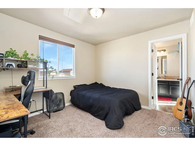 a bedroom with a bed a table and chair