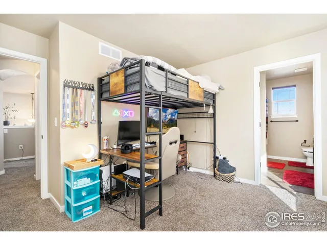 a bedroom with furniture and a mirror