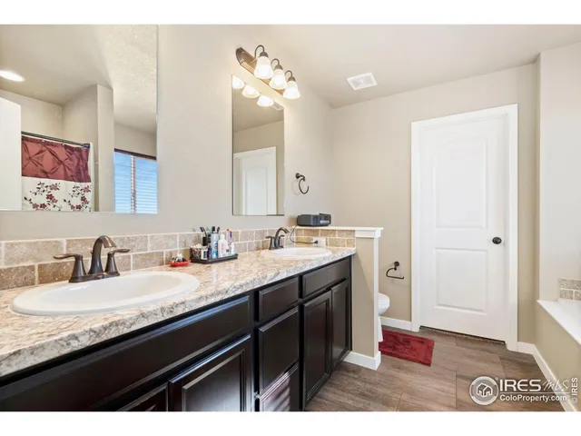 a bathroom with a granite countertop sink a mirror and a