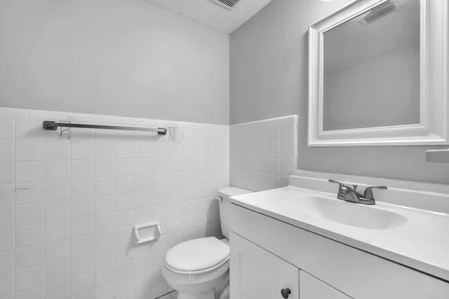a bathroom with a sink toilet and vanity