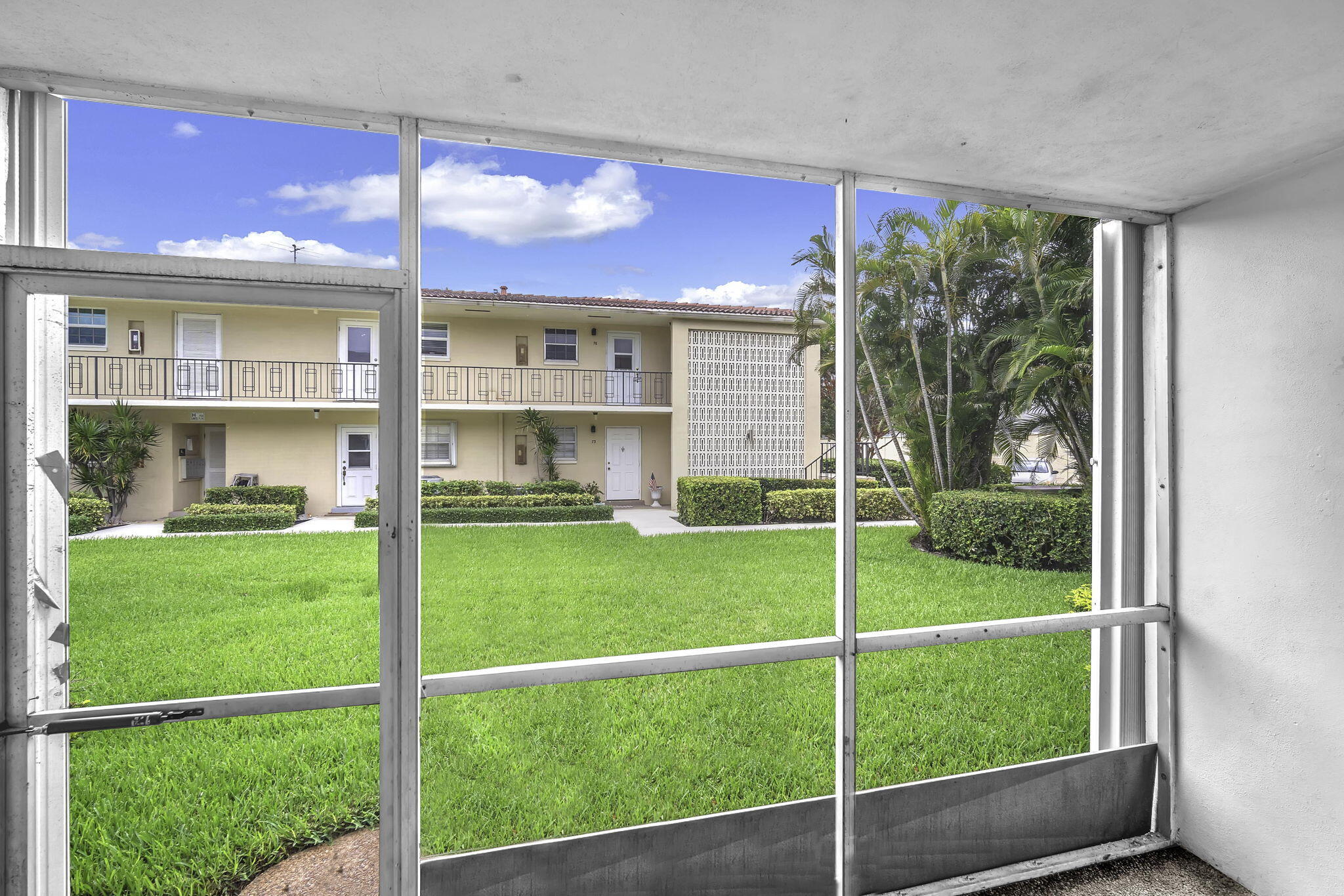2130 Northeast 36th Street, Unit 63 Lighthouse Point, FL 33064 - Photo 19 of 21 a view of a house with a yard and a garden