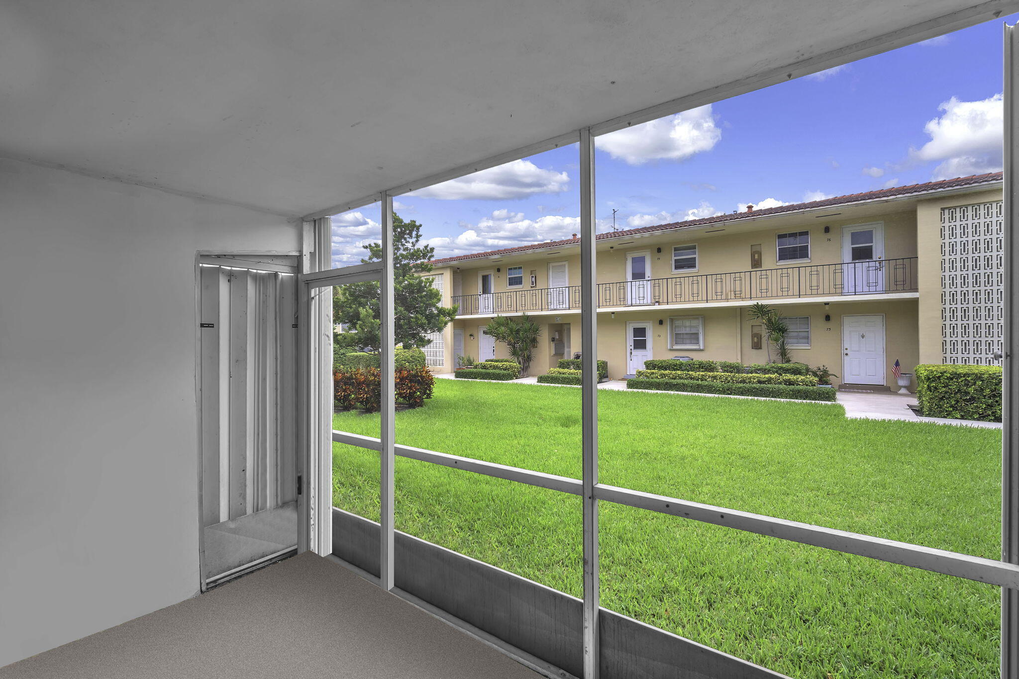 2130 Northeast 36th Street, Unit 63 Lighthouse Point, FL 33064 - Photo 20 of 21 a view of a house with a big yard and large trees
