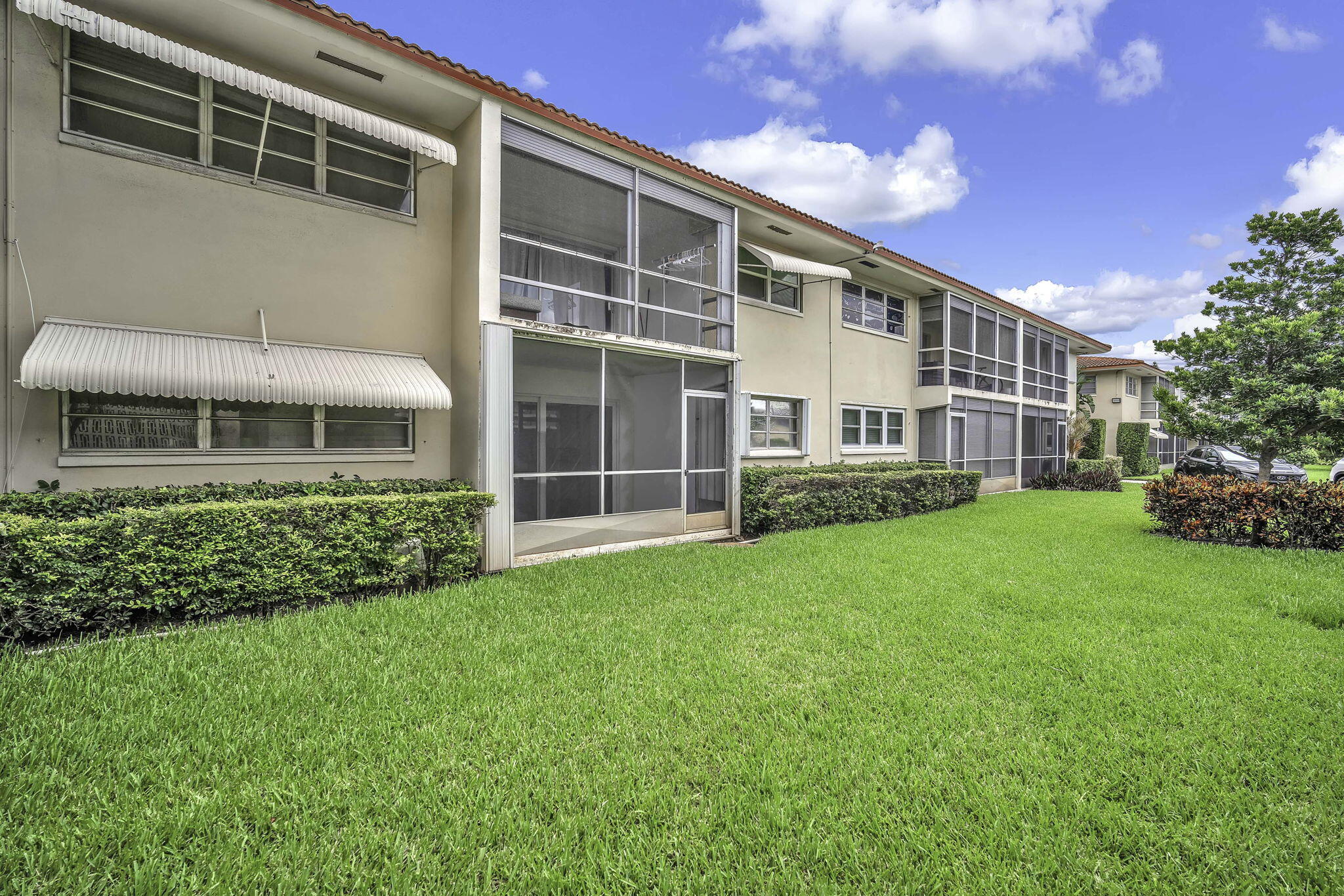 2130 Northeast 36th Street, Unit 63 Lighthouse Point, FL 33064 - Photo 2 of 21 a front view of a house with a yard