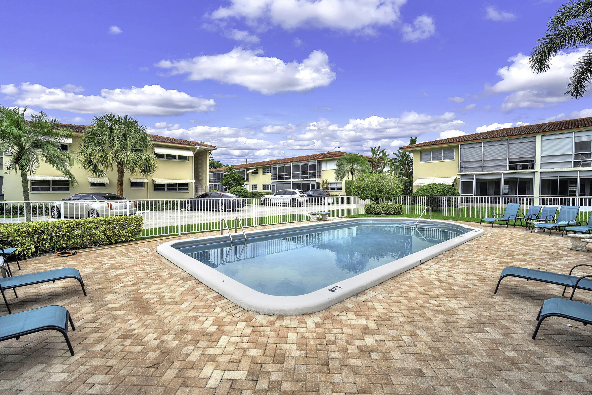 2130 Northeast 36th Street, Unit 63 Lighthouse Point, FL 33064 - Photo 3 of 21 a view of a house with swimming pool and sitting area