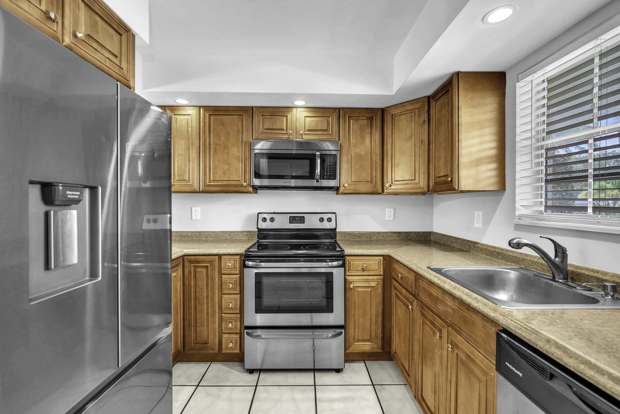 2130 Northeast 36th Street, Unit 63 Lighthouse Point, FL 33064 - Photo 4 of 21 a kitchen with a sink stove and refrigerator