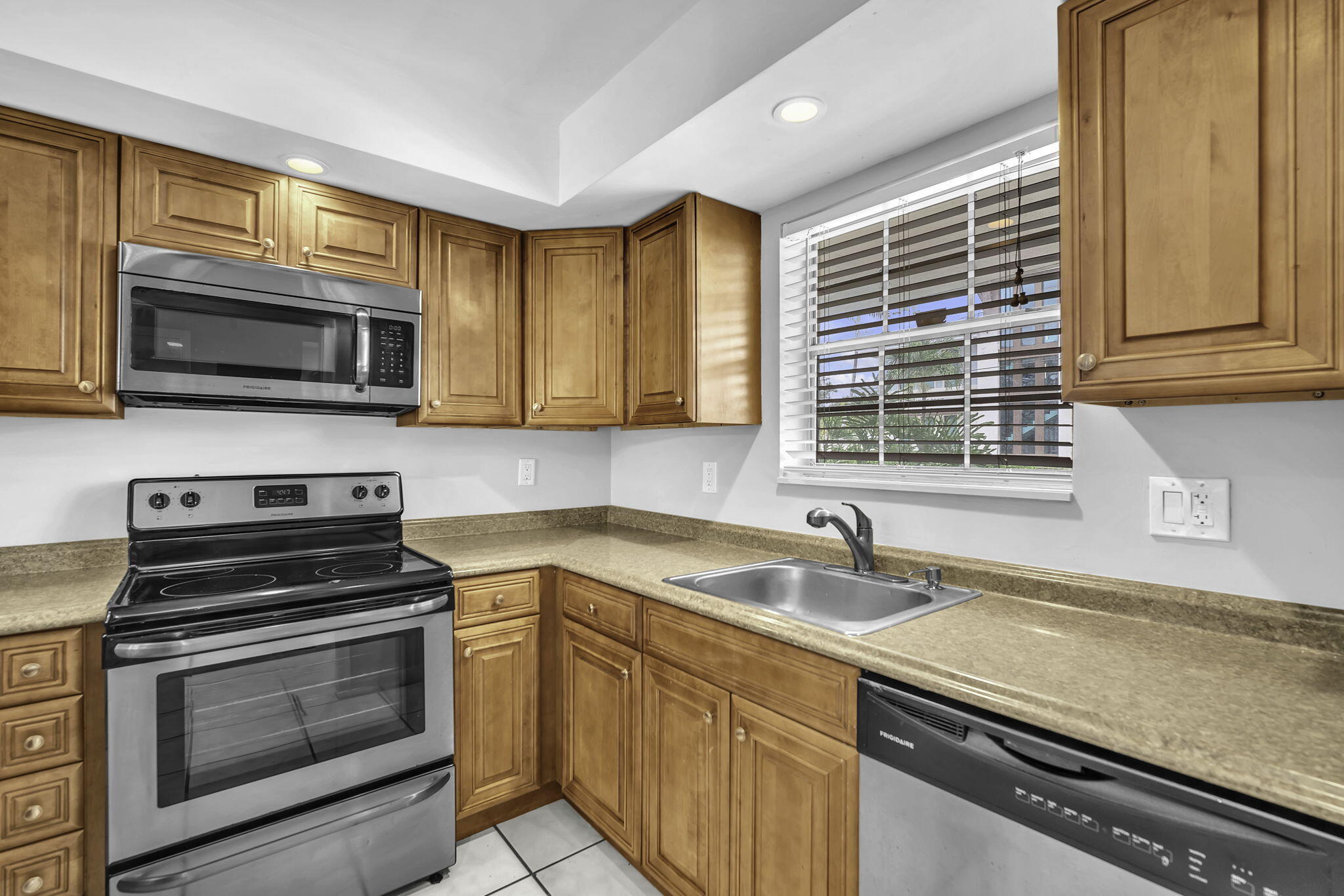 2130 Northeast 36th Street, Unit 63 Lighthouse Point, FL 33064 - Photo 5 of 21 a kitchen with granite countertop a sink and steel appliances