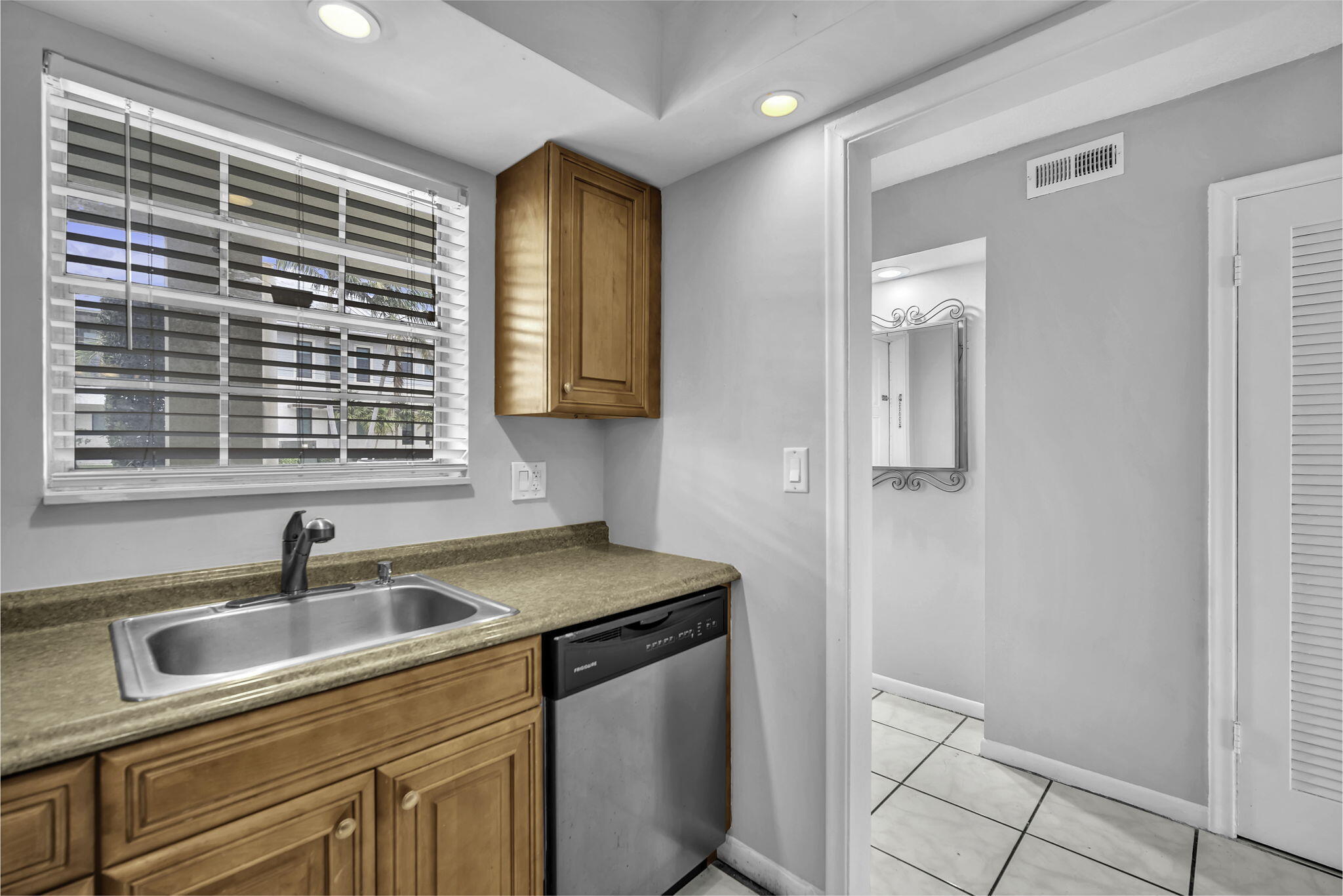 2130 Northeast 36th Street, Unit 63 Lighthouse Point, FL 33064 - Photo 7 of 21 a kitchen that has a sink and a window