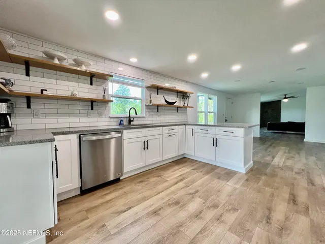 a living room with a bed furniture and a window