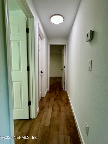 a view of a water fountain in a yard with large trees