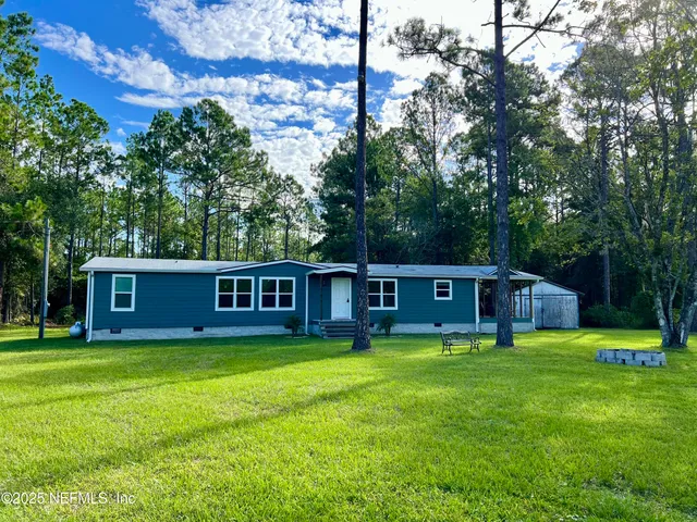 a view of a house with backyard porch and sitting area