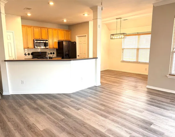 a view of kitchen with wooden floor