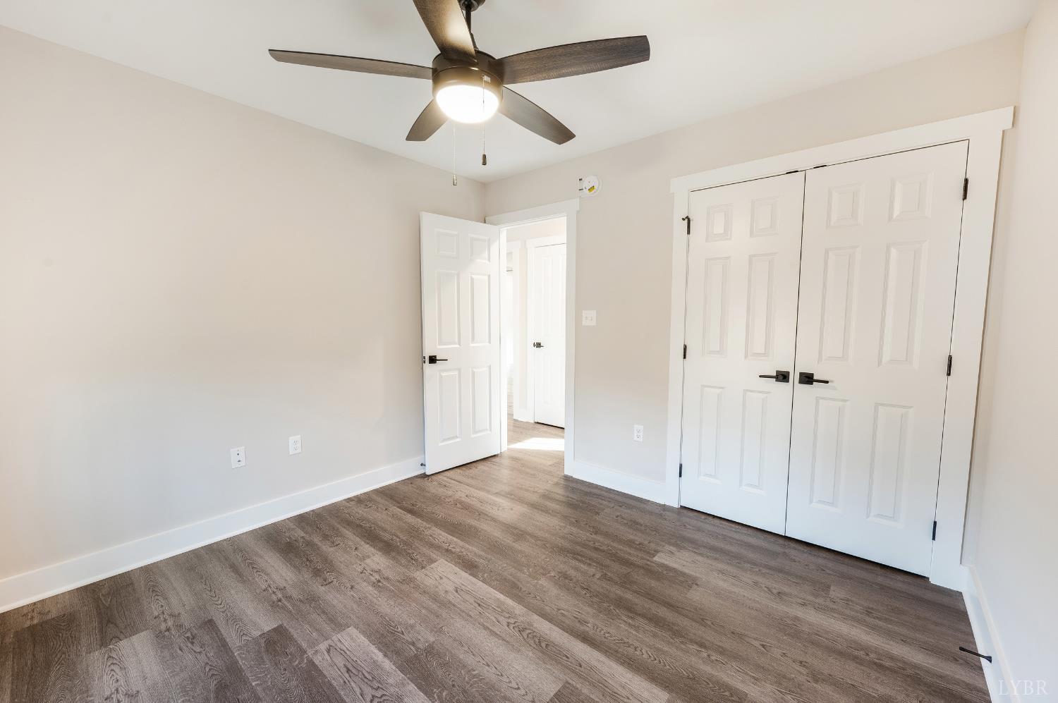 144 Armistead Lane Rustburg, VA 24588 - Photo 34 of 64 an empty room with wooden floor closet fan and windows