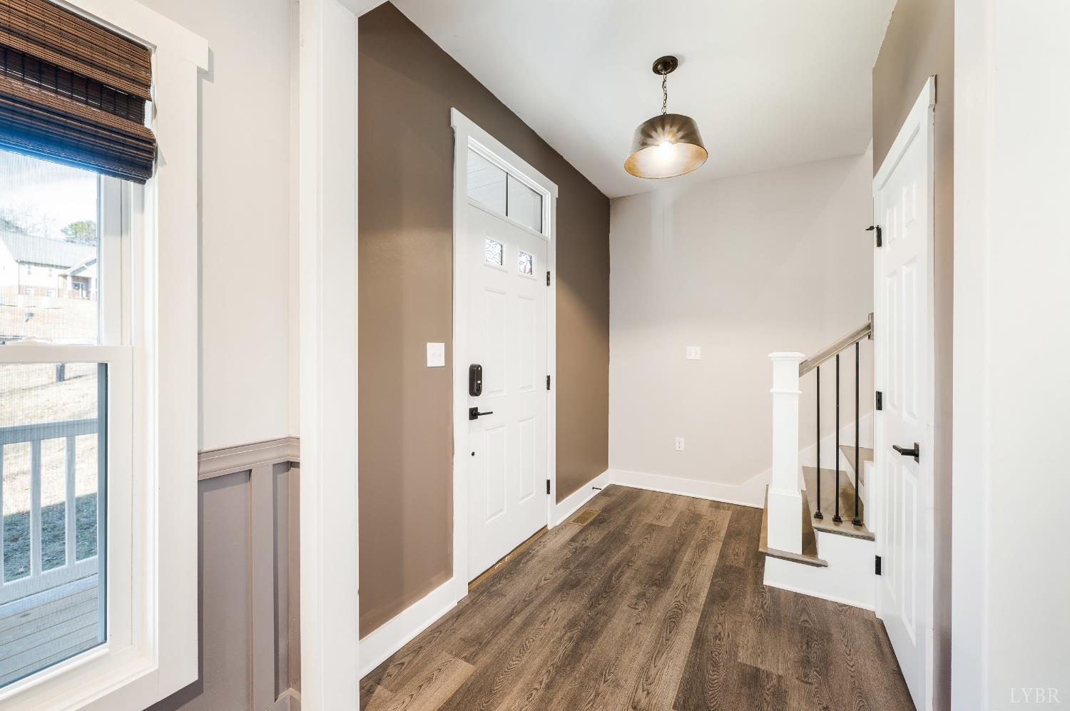 144 Armistead Lane Rustburg, VA 24588 - Photo 4 of 64 a view of a hallway with wooden floor and staircase
