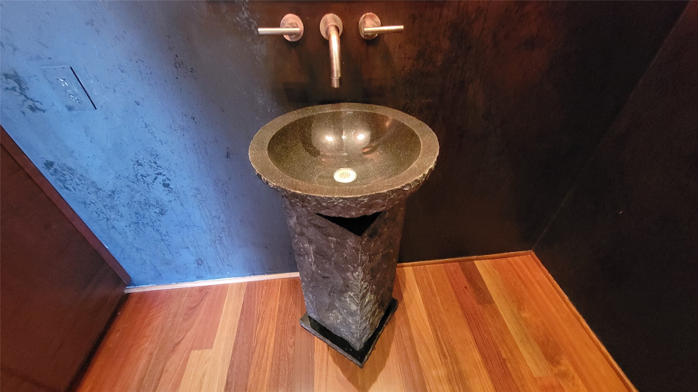 711 Main Street, Unit PH 1003 Houston, TX 77002 - Photo 22 of 32 Very Modern stone pedestal sink in powder bath with Venetian plaster walls.
