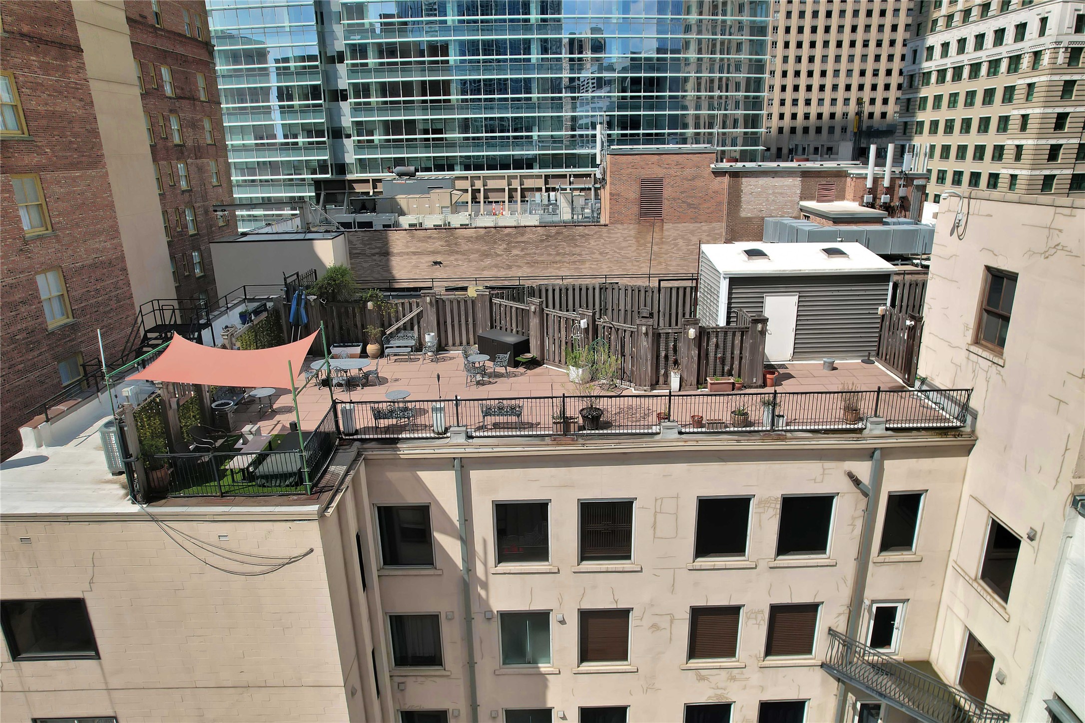 711 Main Street, Unit PH 1003 Houston, TX 77002 - Photo 28 of 32 Top row of windows are of the penthouse. Almost 1100 sq ft private terrace shown with reddish concrete tile patio.