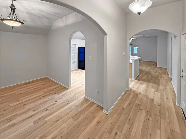 a view of a room with wooden floor