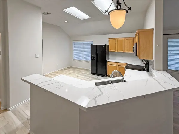 a kitchen with a sink a stove and a microwave oven