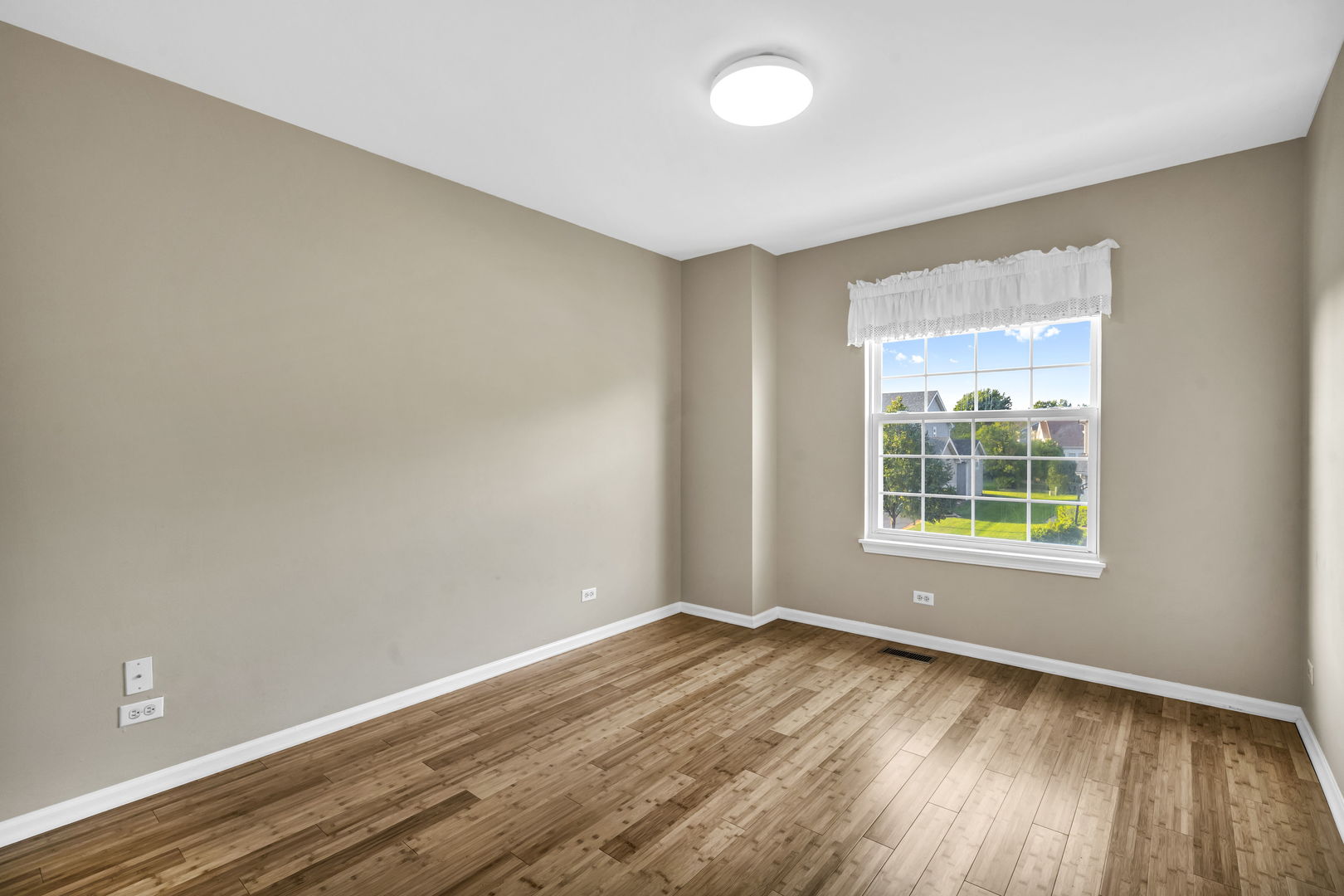 2241 Avalon Court South Buffalo Grove, IL 60089 - Photo 13 of 25 an empty room with wooden floor and windows