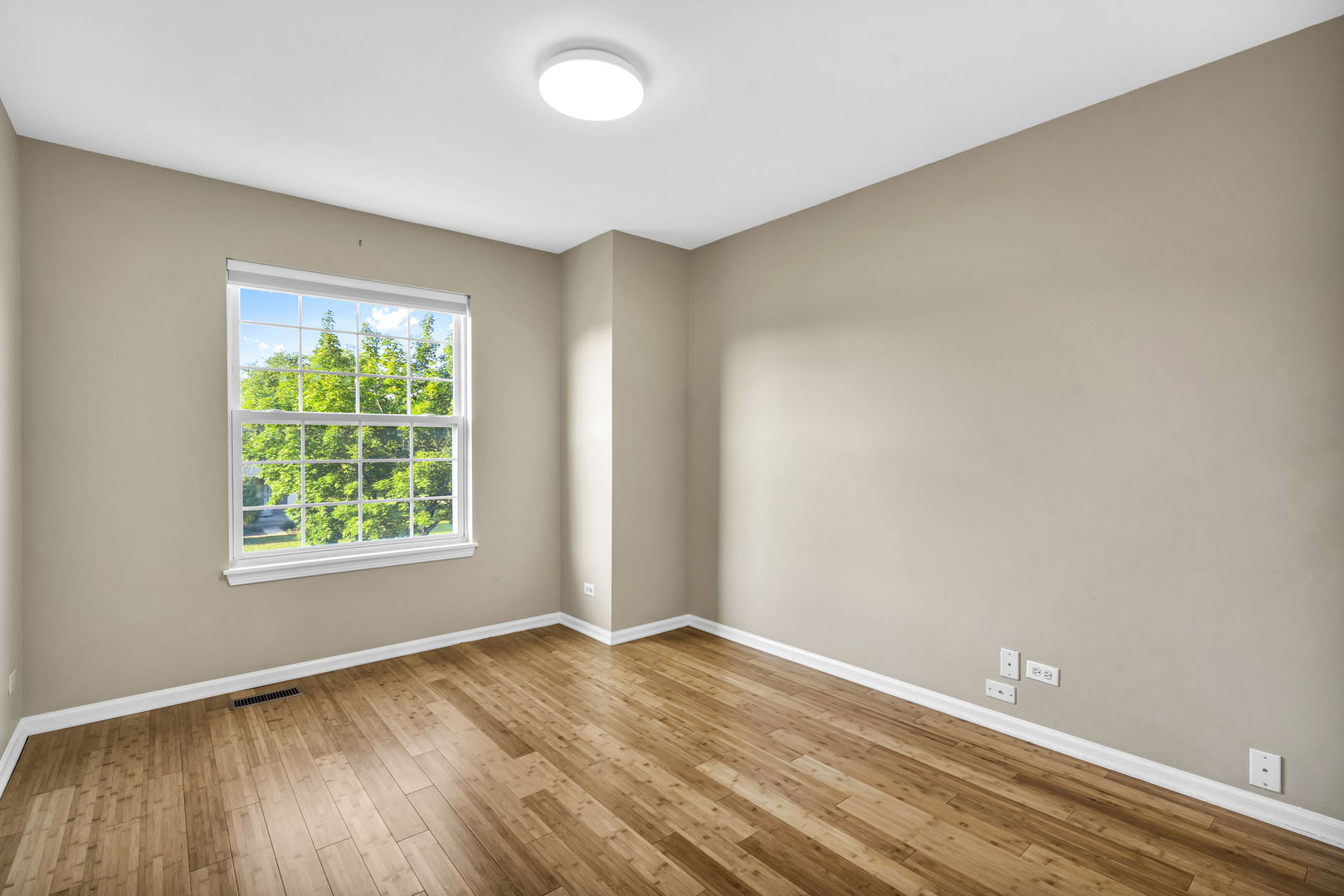 2241 Avalon Court South Buffalo Grove, IL 60089 - Photo 14 of 25 an empty room with wooden floor and windows