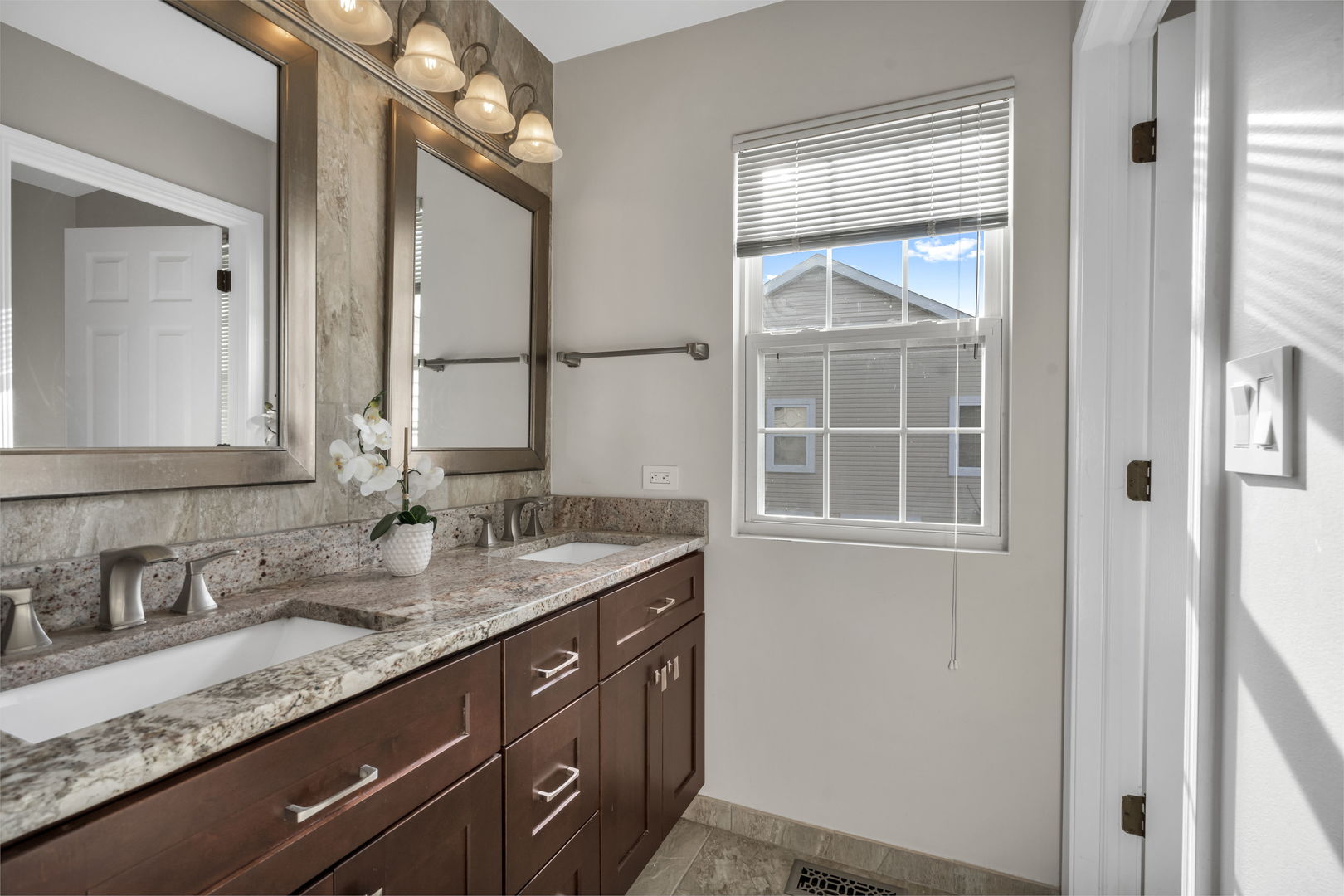 2241 Avalon Court South Buffalo Grove, IL 60089 - Photo 16 of 25 a bathroom with a granite countertop sink and a mirror