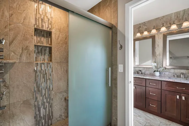 a bathroom with a double vanity sink a toilet and a mirror