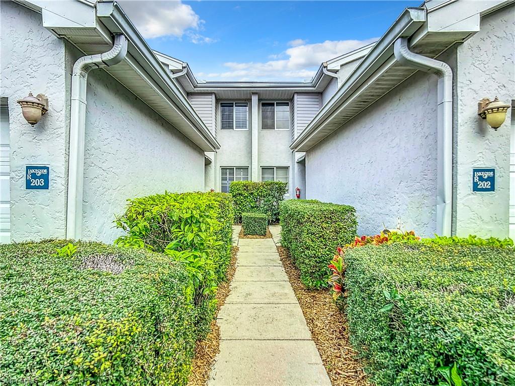 2860 Citrus Lake Drive, Unit R202 Naples, FL 34109 - Photo 3 of 50 a view of a pathway along with potted plants