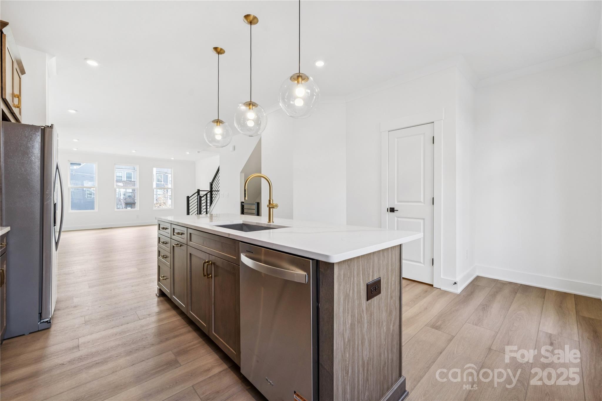 3640 South Tryon Street, Unit 24 Charlotte, NC 28217 - Photo 5 of 25 a kitchen with a sink a refrigerator and wooden floor
