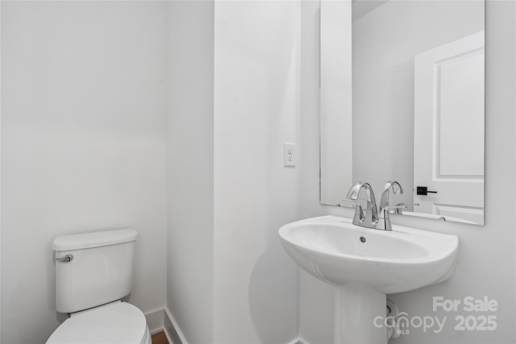 3640 South Tryon Street, Unit 24 Charlotte, NC 28217 - Photo 8 of 25 a bathroom with a toilet sink and mirror