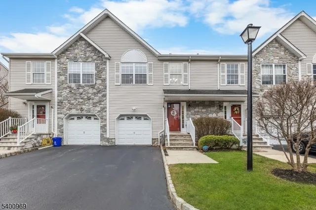 a front view of a house with a garden and plants