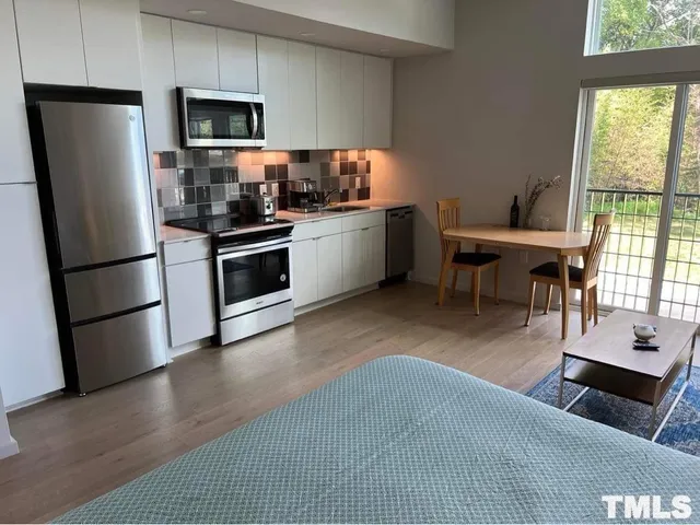 a kitchen with a stove microwave and sink