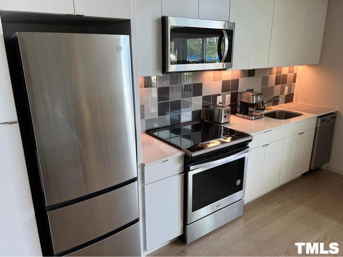 600 South Duke Street, Unit 15 Durham, NC 27701 - Photo 7 of 20 a kitchen with a stove microwave and sink