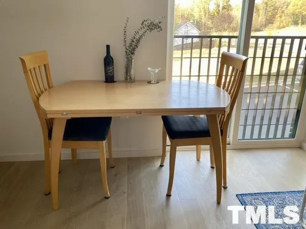 a living room with furniture a table and a large window