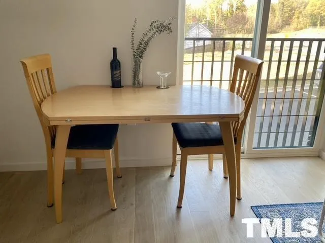 a living room with furniture a table and a large window