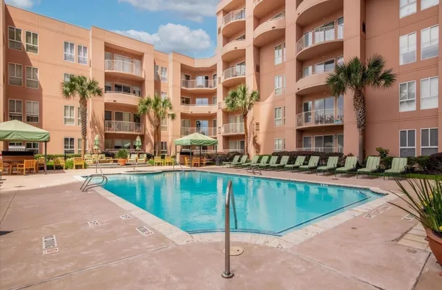 a swimming pool with outdoor seating and yard
