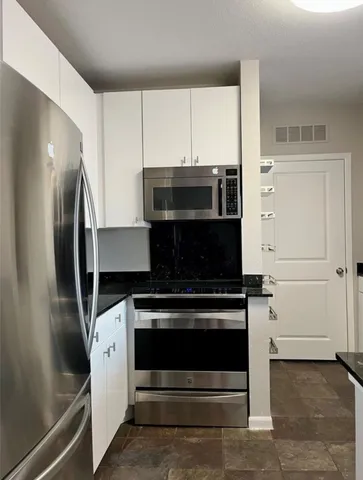 a stove top oven sitting inside of a kitchen