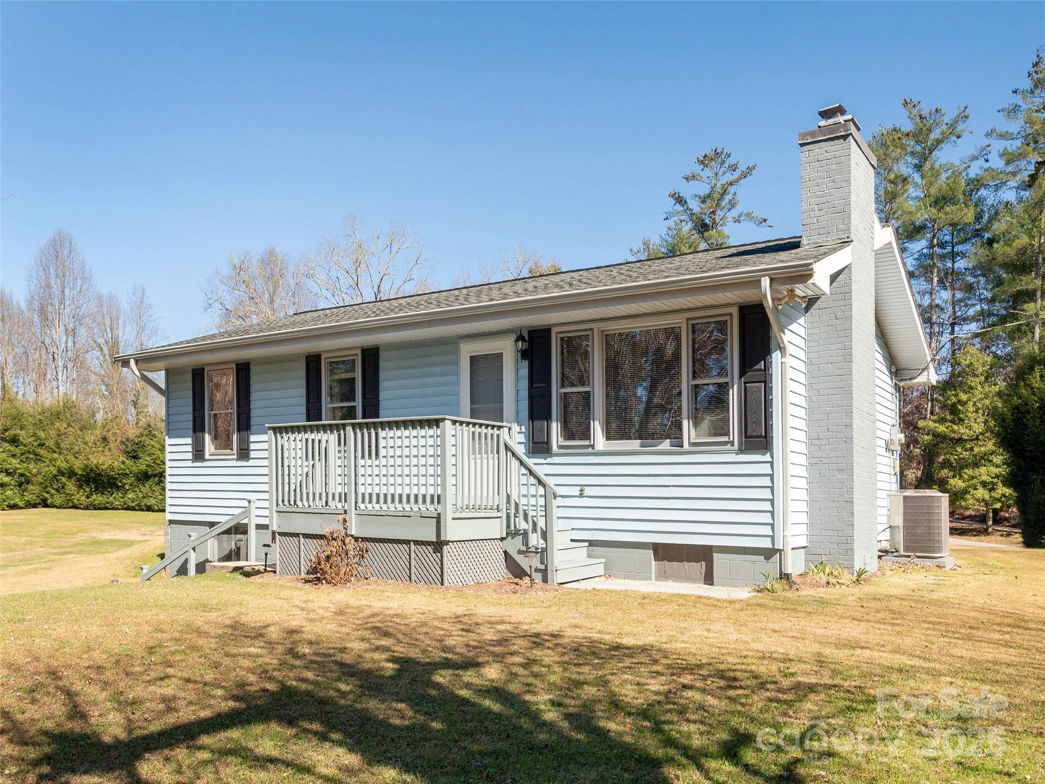 3021 Kanuga Road Hendersonville, NC 28739 - Photo 1 of 24 a front view of a house with a yard