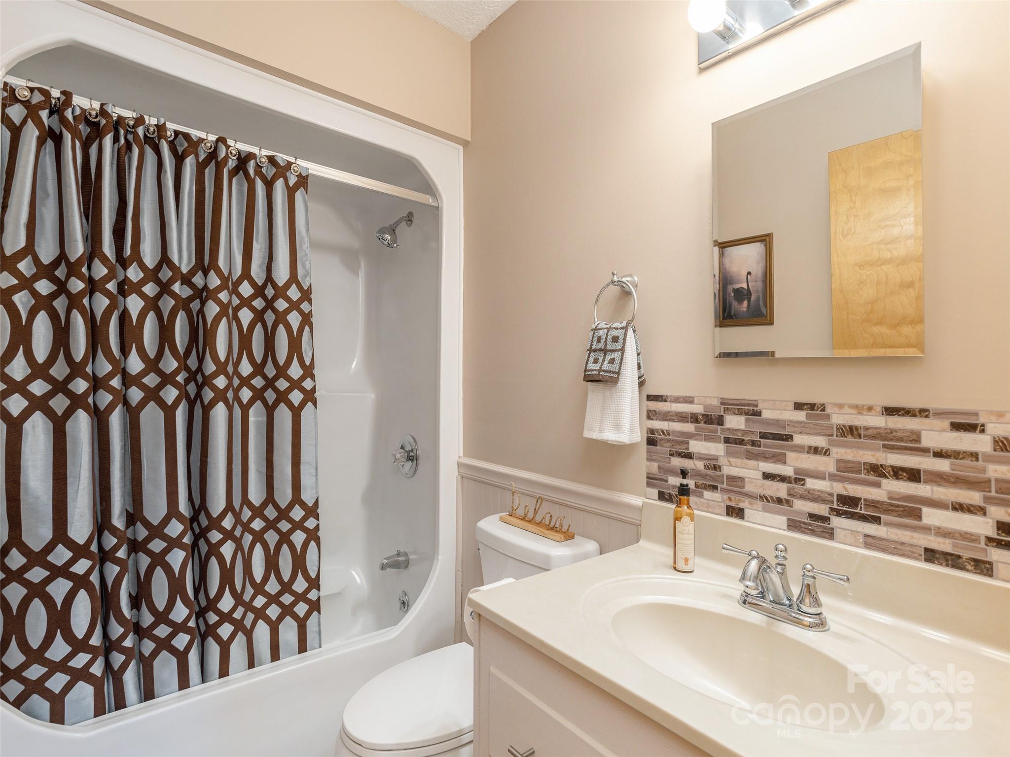 3021 Kanuga Road Hendersonville, NC 28739 - Photo 11 of 24 a bathroom with a sink and a mirror