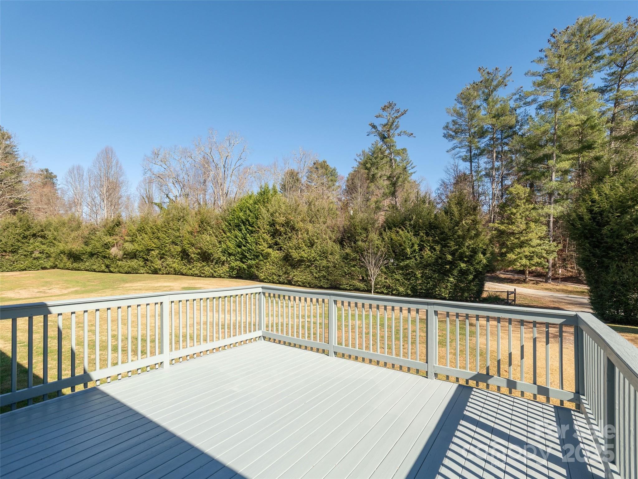 3021 Kanuga Road Hendersonville, NC 28739 - Photo 16 of 24 a view of wooden deck and a garden