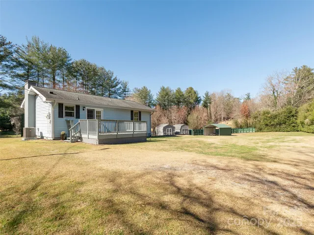 a view of a house with pool and a yard