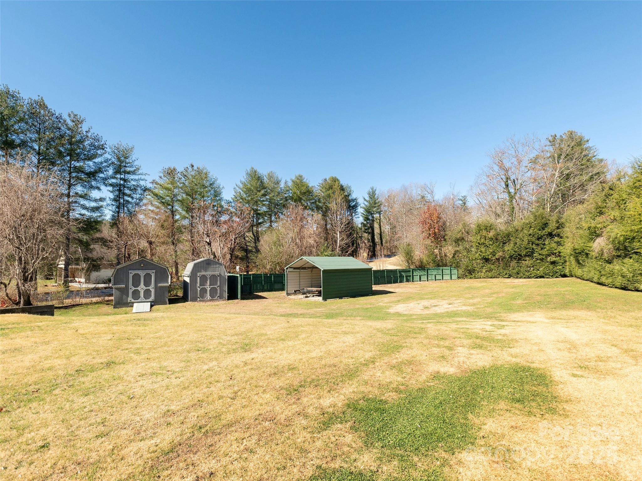 3021 Kanuga Road Hendersonville, NC 28739 - Photo 18 of 24 a view of swimming pool and trees in the background