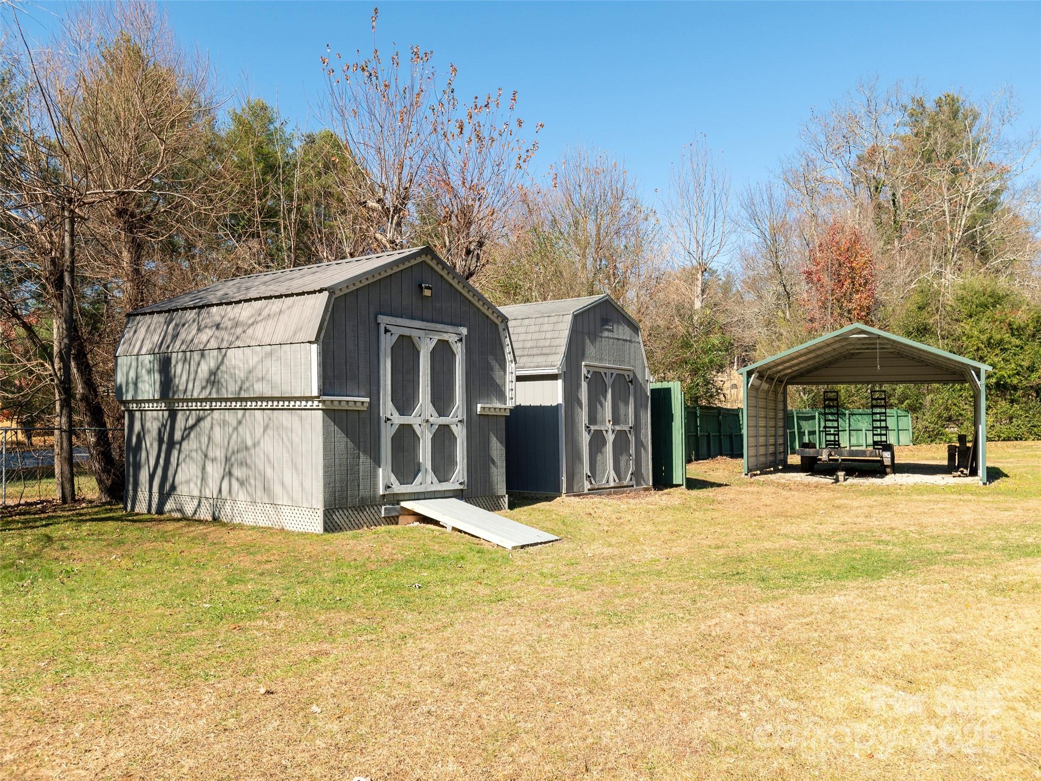 3021 Kanuga Road Hendersonville, NC 28739 - Photo 20 of 24 a front view of a house with a yard covered with snow