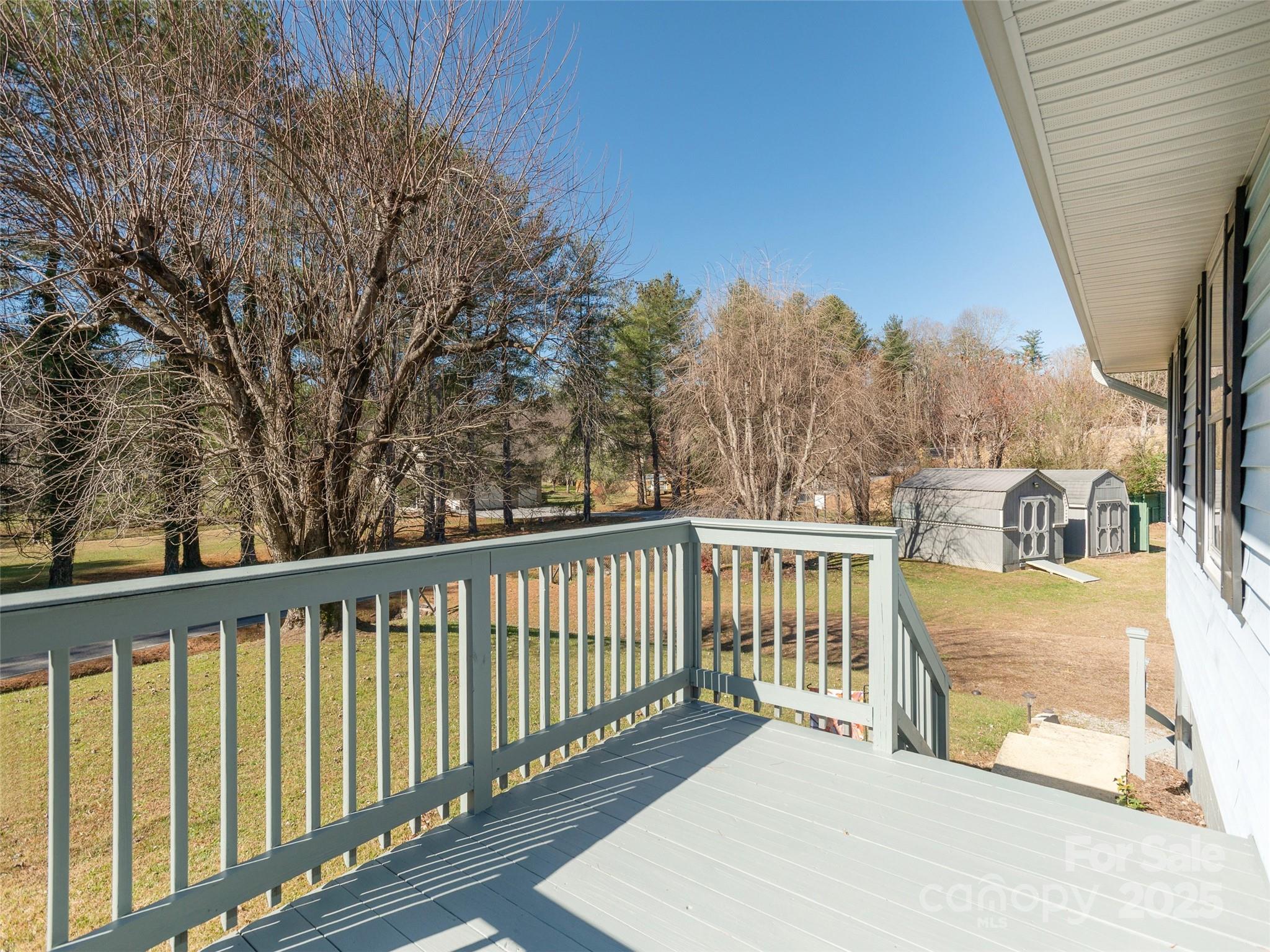 3021 Kanuga Road Hendersonville, NC 28739 - Photo 2 of 24 a view of a two chairs on the roof deck