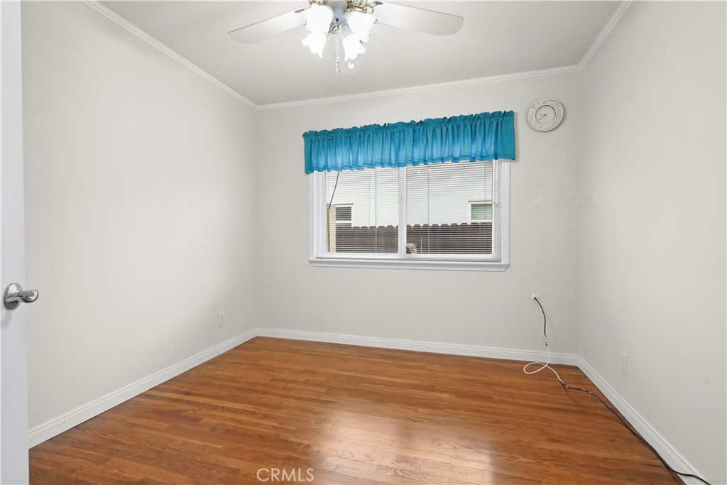 17068 Celtic Street Granada Hills, CA 91344 - Photo 12 of 21 an empty room with wooden floor and windows