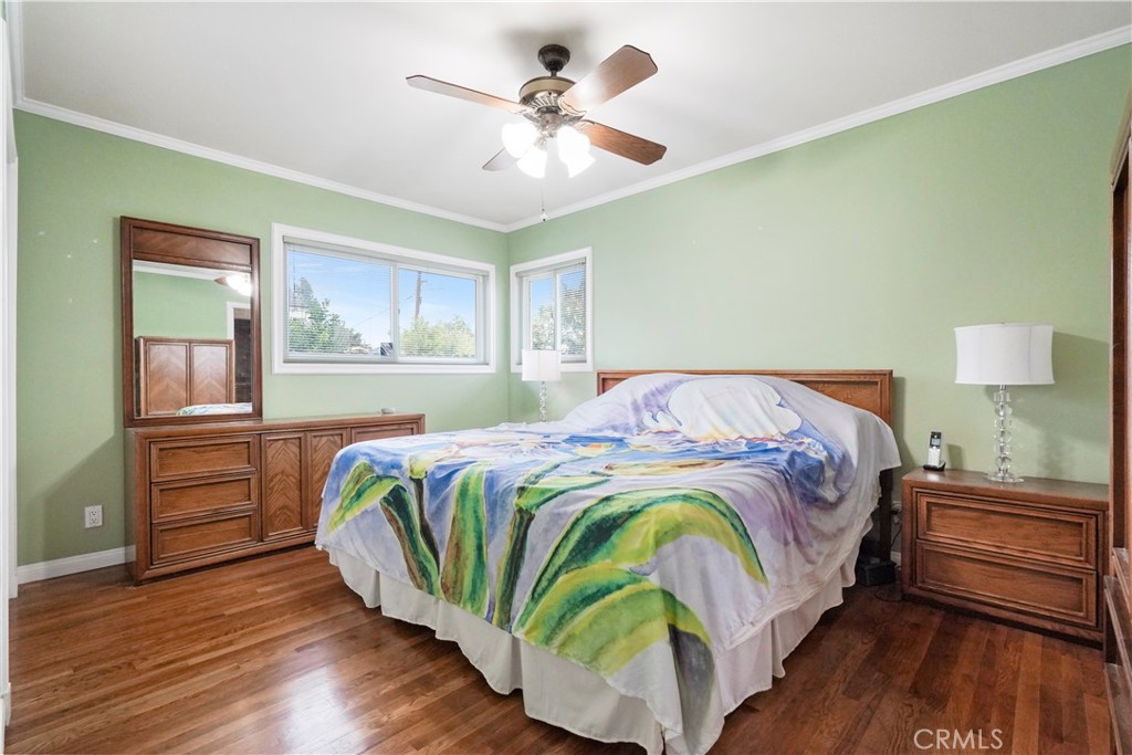 17068 Celtic Street Granada Hills, CA 91344 - Photo 13 of 21 a bedroom with a bed and wooden floor
