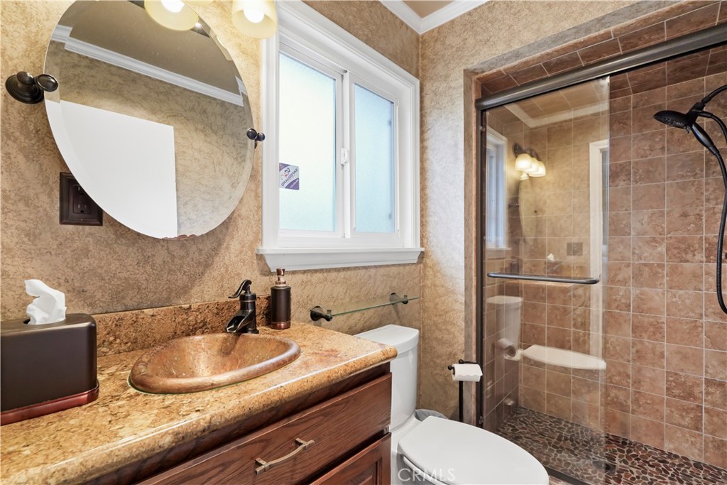 17068 Celtic Street Granada Hills, CA 91344 - Photo 14 of 21 a bathroom with a sink toilet and mirror