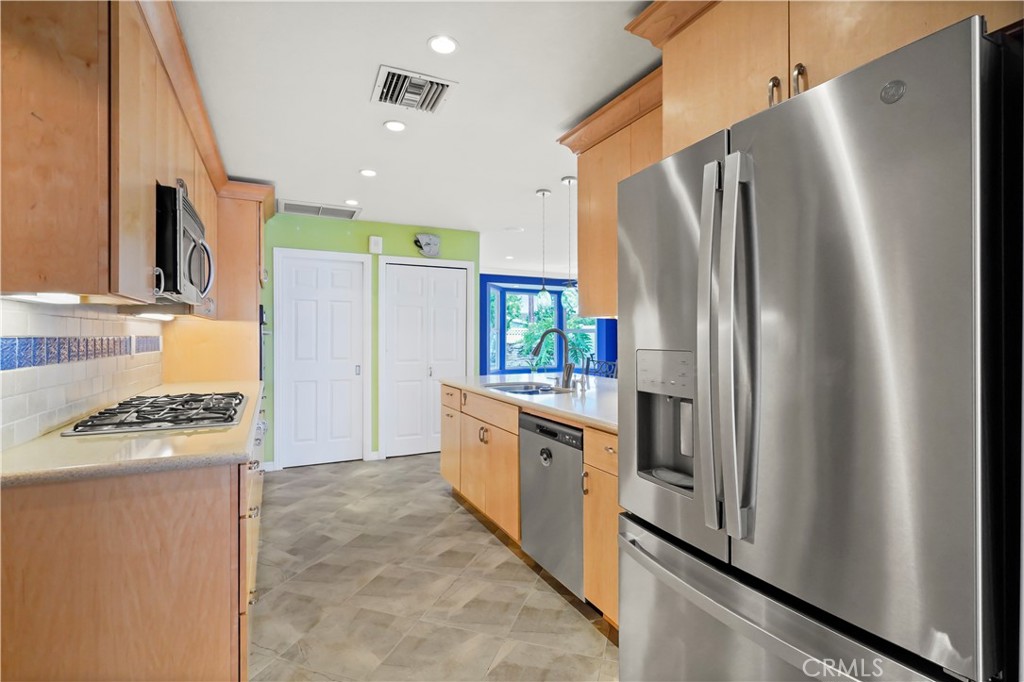 17068 Celtic Street Granada Hills, CA 91344 - Photo 8 of 21 a kitchen with stainless steel appliances a refrigerator and a stove