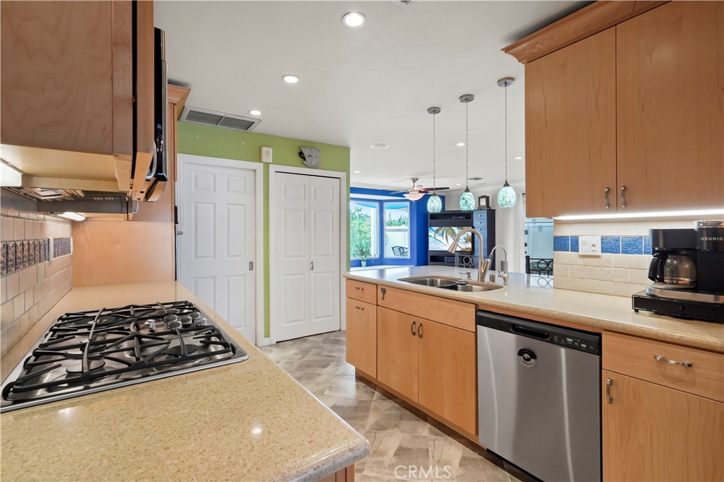 17068 Celtic Street Granada Hills, CA 91344 - Photo 9 of 21 a kitchen with sink a stove and cabinets