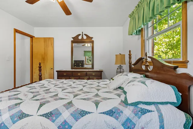 a view of a bedroom with wooden floor and stairs