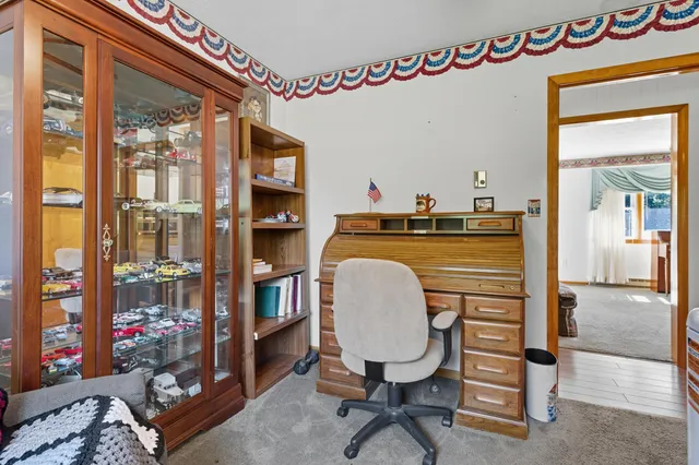 a dining room with furniture and a refrigerator