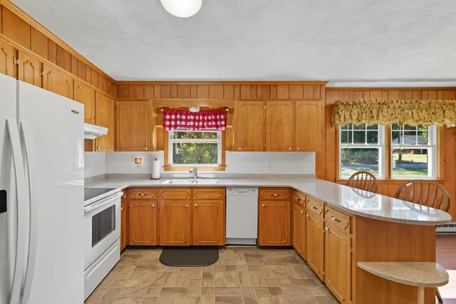 a kitchen with stainless steel appliances a sink and a refrigerator